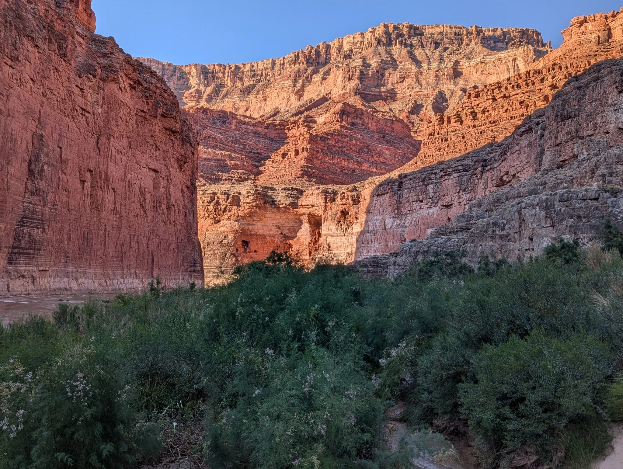 Sunlit red-rock canyon and river landscape